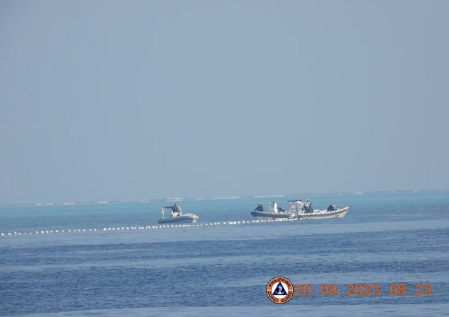 Xuồng hải cảnh Trung Quốc thả dây phao tại bãi cạn Scarborough tại Biển Đông ngày 20/9. Ảnh: Reuters